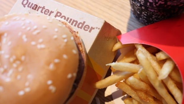 A photo illustration shows a Quarter Pounder and some related packaging as part of a hamburger meal.