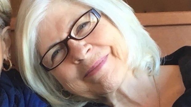 Gloria Lemay, an older woman with a white bob haircut and black glasses, smiles in a Facebook profile photo.