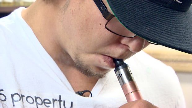 man smokes 3 e-cigarette