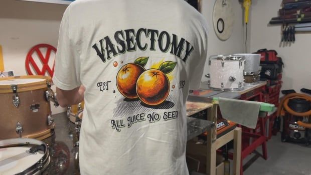 A closeup shows the back of a man's white T-shirt, with a graphic showing two oranges and the words "Vasectomy - All Juice, No Seed."