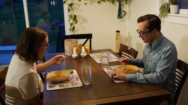 A couple eating dinner at their home.