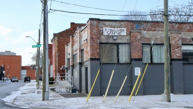 A brick building on an urban street corner. 