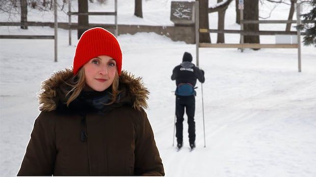 Reporter in brown winter jacket superimposed in front of blurred cross country skier on the snow.