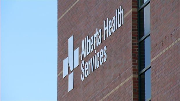 An Alberta Health Services sign on a brick building.