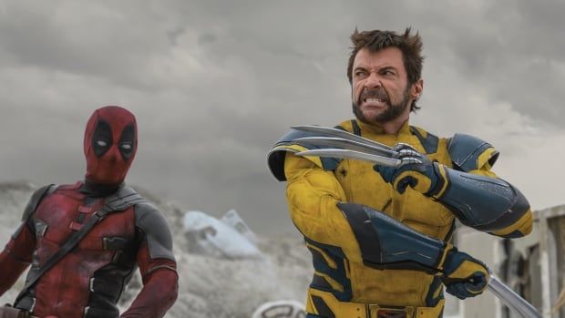 Deadpool and Wolverine in super hero costume prepare for battle, angry and weapons drawn. 