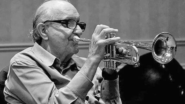 Black and white photo of Jack Long playing a trumpet.