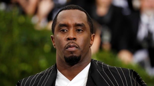 Sean (Diddy) Combs in a black and silver spider web suit and cape arriving at the Metropolitan Museum of Art Costume Institute Gala in New York City in 2017.