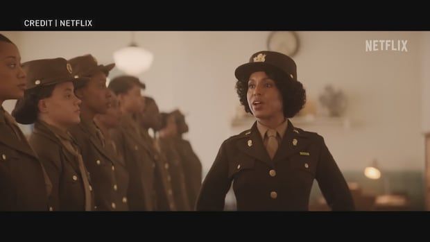 A still from a movie showing a female soldier speaking in front of a line of other soldiers.