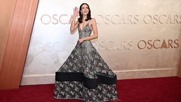 Stacy Martin on the red carpet wearing a sparkly black and white dress. 