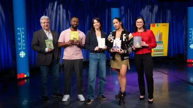 Five people pose in studio holding five books.