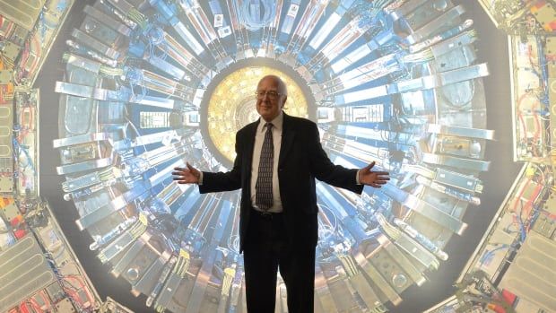 Man in front of photo of an Atlas detector