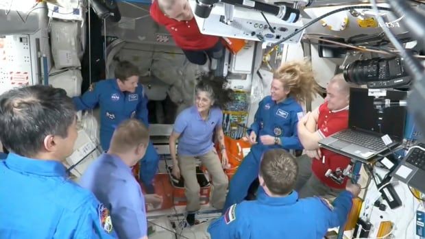 Astronauts greet each other on the International Space Station.