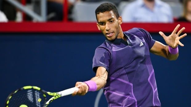 A men's tennis player hits a forehand shot.