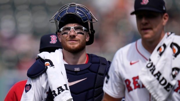 A baseball catcher walks.