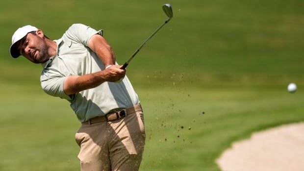 A male golfer is seen hitting a ball.