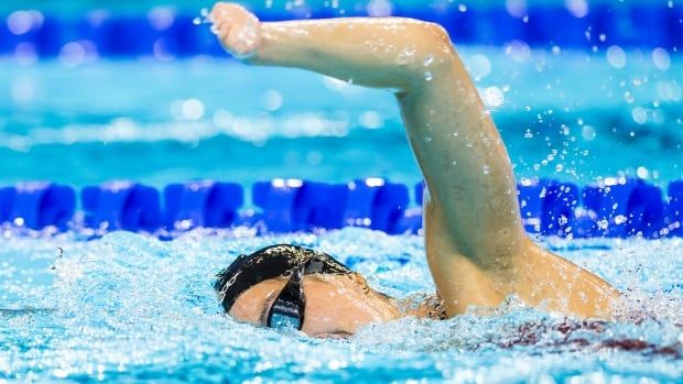 A female Paralympic swimmer competes in a freestyle event.