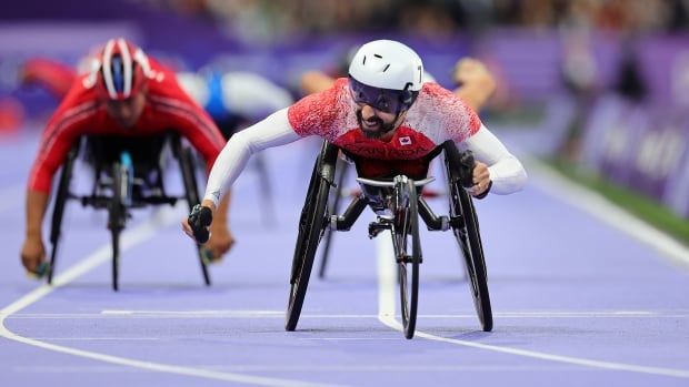 A wheelchair racer glides along the track.