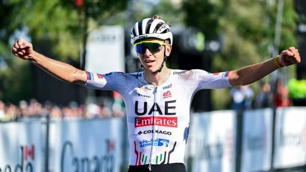 A cyclist celebrates on his bike.