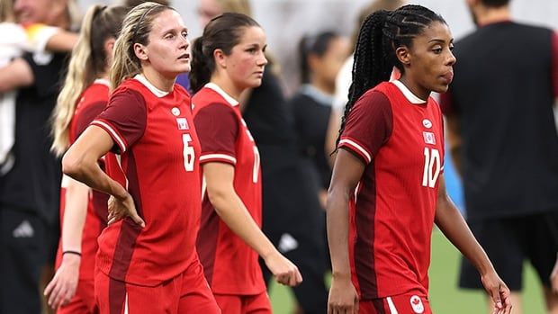 Canadian women's soccer player Ashley Lawrence and her teammates walk off the pitch following an Olympic quarterfinal loss to Germany on Aug. 3, 2024 in Marseille, France. 