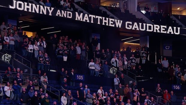 Fans stand for a 13-second moment of silence in memory of Columbus Blue Jackets forward Johnny Gaudreau and his brother Matthew before the start of an NHL pre-season game against the St. Louis Blues on Sept. 25, 2024 in Ohio.