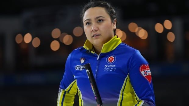 A female curler is seen from up close.