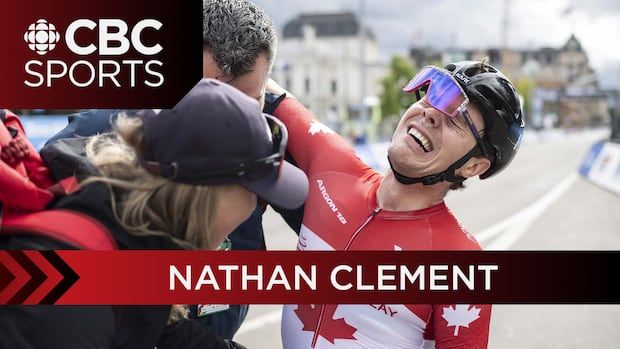 Man in helmet with shades smiles after winning race 