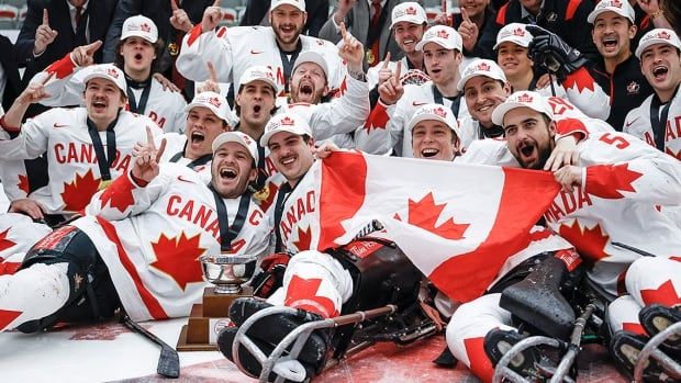 Canadian men's Para hockey team poses for a celebratory photo on the ice after beating the United States at the world championships on May 12, 2024 in Calgary, Alberta.