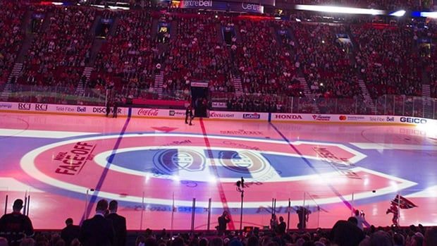 The Montreal Canadiens logo is projected onto the ice during a pre-game ceremony prior to their NHL hockey home opener against Chicago on Oct. 10, 2017. 