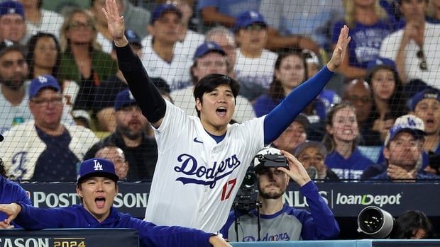 Shohei Ohtani and a couple of his Los Angeles Dodgers teammates react to a close call on first base during the Game Six of the National League Championship Series against the New York Mets at Dodger Stadium on Oct. 20, 2024.