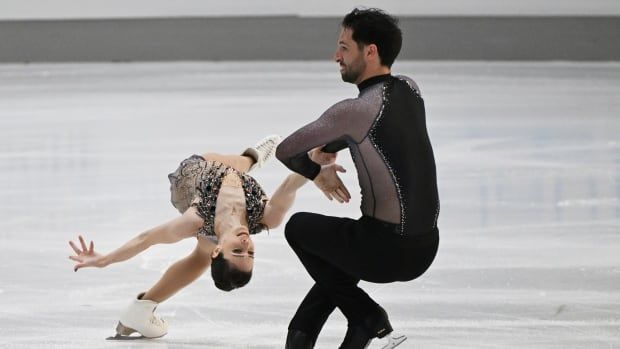 A pairs figure skating team competes.