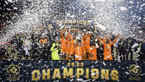 Forge FC teammates lift the North Star Cup following their Canadian Premier League finals win against Cavalry FC in Hamilton on Saturday, Oct. 28, 2023. 