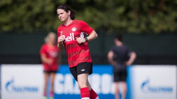 A women's soccer player runs during training.