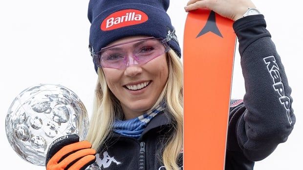 American Mikaela Shiffrin, the 2023-24 overall season winner, celebrates with the Crystal Globe during a photo call during the World Cup final in Saalbach, Austria on March 17, 2024.