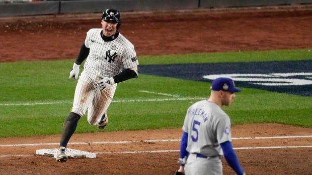 A men's baseball player rounds the bases.