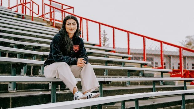 woman sitting on bleachers