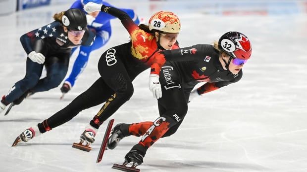 Speed skaters race.