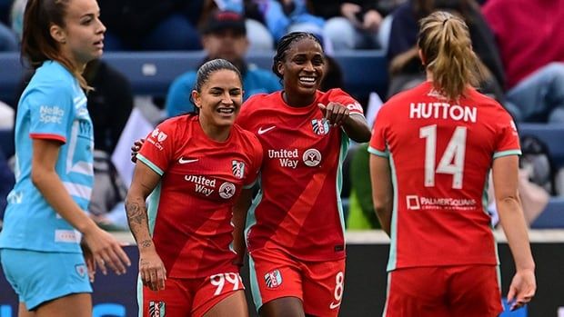 Kansas City forward Nichelle Prince of Ajax Ont., celebrates with a couple of teammates after scoring her club's third goal in a 3-1 victory over Chicago Red Stars at SeatGeek Stadium in Bridgeview, Illinois. Mandatory Credit: Daniel Bartel-Imagn Images 