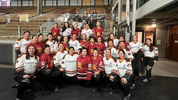 A team photo of women in white, maroon, and black uniforms 