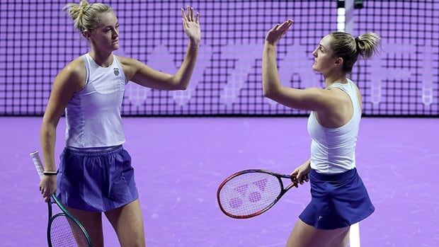 Canada’s Gabriela Dabrowski and her partner, Erin Routliffe of New Zealand, high-five each other in celebration of a point scored against Americans Desirae Krawczyk and Caroline Dolehide in their round robin doubles match at the WTA Finals on Nov. 7, 2024 in Riyadh, Saudi Arabia.