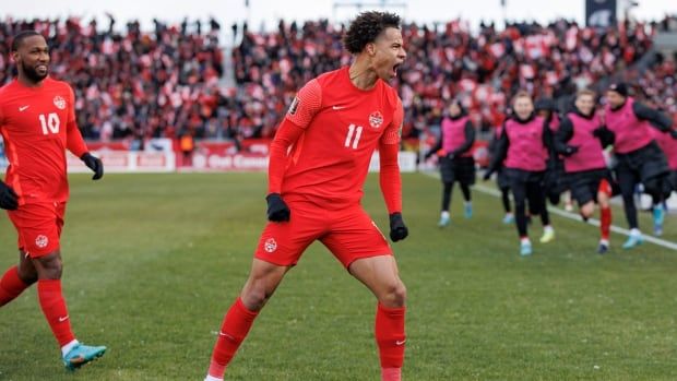 A men's soccer player celebrates.