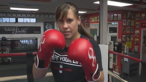 A women's boxer stands in her stance.