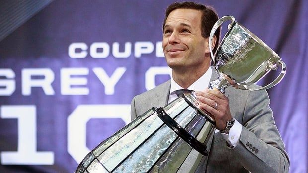 Mark Cohon, pictured during his tenure as Canadian Football League commissioner, carries the Grey Cup on the field during the 102nd championship game at BC Place Stadium in Vancouver on Nov. 30, 2014.  