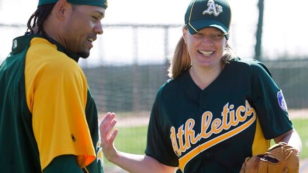  Oakland Athletics coach Justine Siegal talks with outfielder Coco Crisp before pitching batting practice during spring training in Phoenix, Arizona on Feb. 23, 2011.