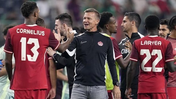 Canadian men's male soccer coach talks with male players after the team's international friendly soccer match against Mexico Tuesday, Sept. 10, 2024, in Arlington, Texas.