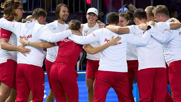 Tennis player Iga Swiatek celebrates victory over Spain with her Polish teammates at the Billie Jean King Cup Finals on Nov. 15, 2024 in Malaga, Spain. 