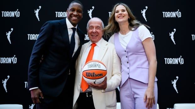 Toronto Raptors male president Masai Ujiri, male owner of Kilmer Sports Ventures, centre, and femaile WNBA Toronto team president pose for a photo during a press conference announcing the city's WNBA franchise in Toronto on Thursday, May 23, 2024.