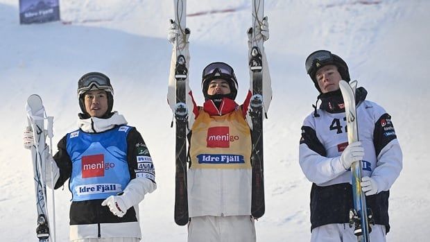 From left: Japan's Horishima Ikuma, who finished second, winner Mikael Kingsbury from Canada and Sweden's Walter Wallberg stand at the bottom of the ski hill after the men's World Cup moguls competition on Dec. 6, 2024 in Idre Fjall, Sweden.