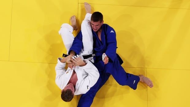 Two judo competitors on the mat, seen from above