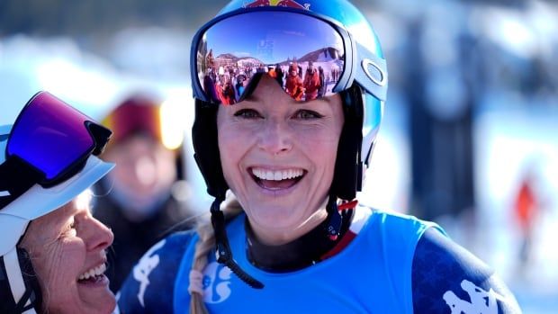 A woman skier smiles.