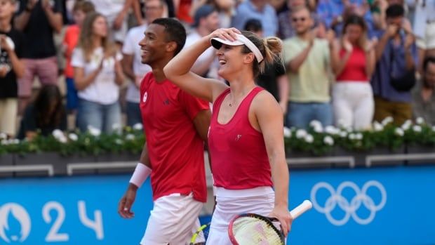 A mixed doubles team react after a victory.